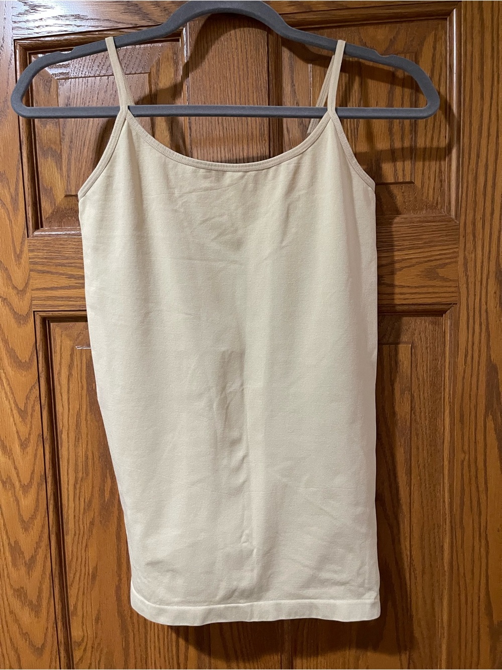 Beige camisole tank top with thin straps shaping under layer
